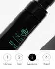 Black skincare bottle with green text on a white background