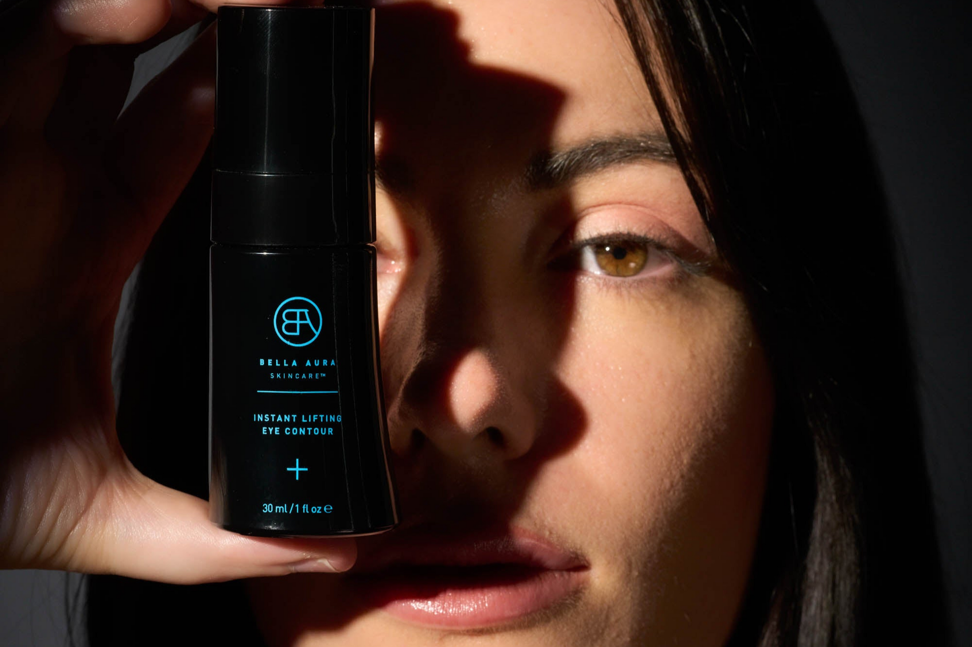 woman face with bella aura bottle
