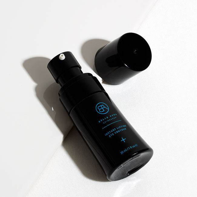 Black glass bottle bella aura instant lifting eye contour with a cap on a white background
