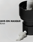 Black skincare pump with white leave-on masque cream on a light gray background