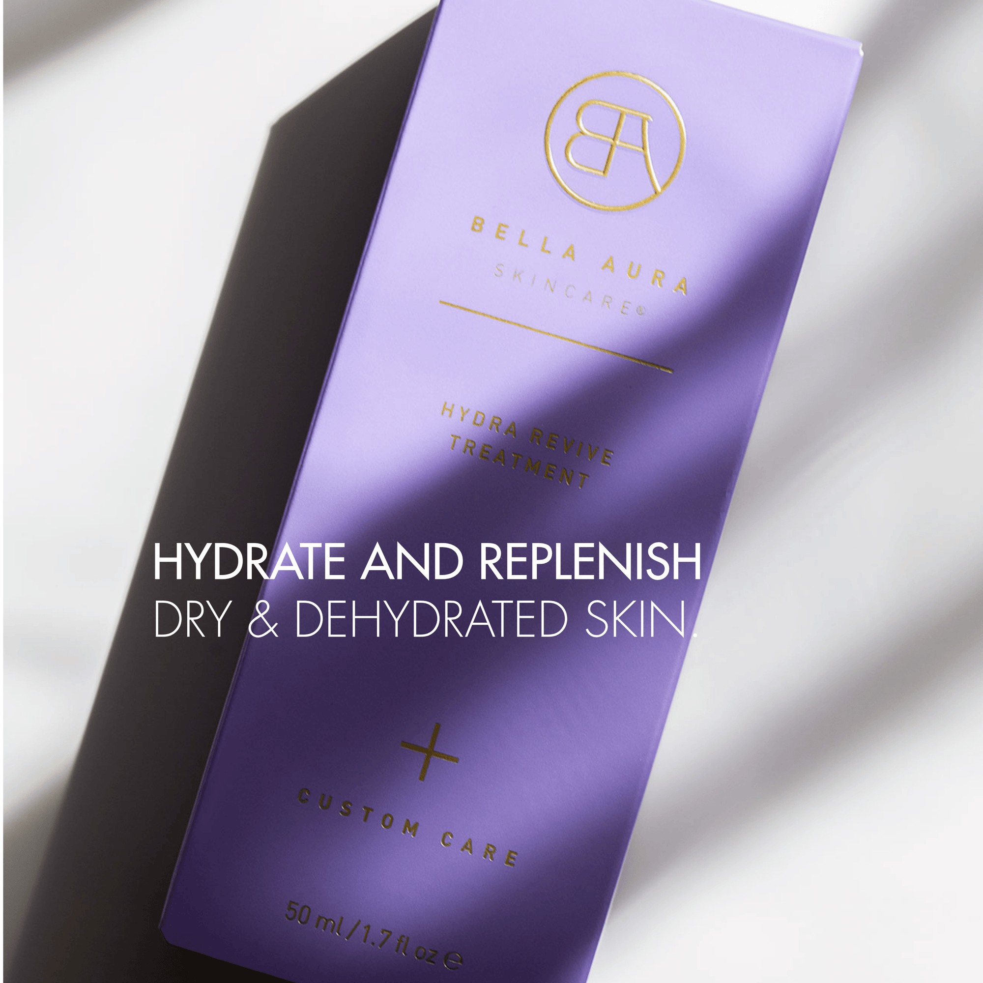 Purple skincare product packaging with Bella Aura branding on a light background