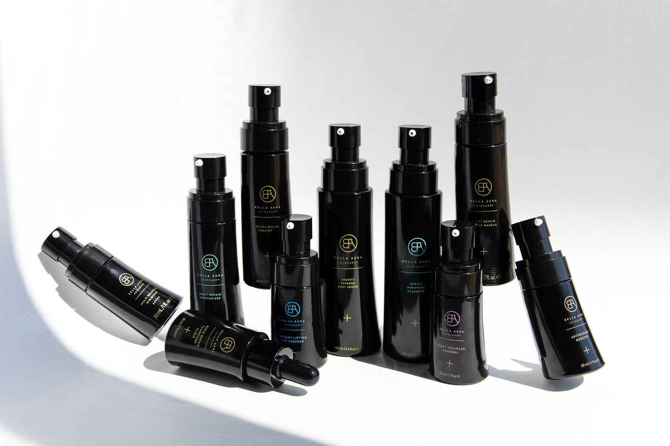 bella aura black glass bottles on a neutral background