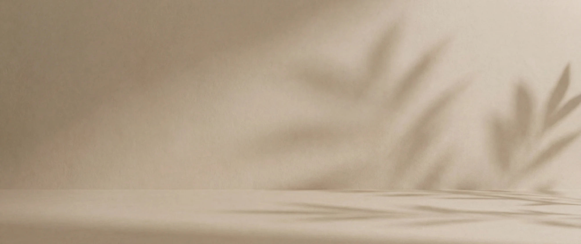 Beige fabric with shadow of leaves on a neutral background