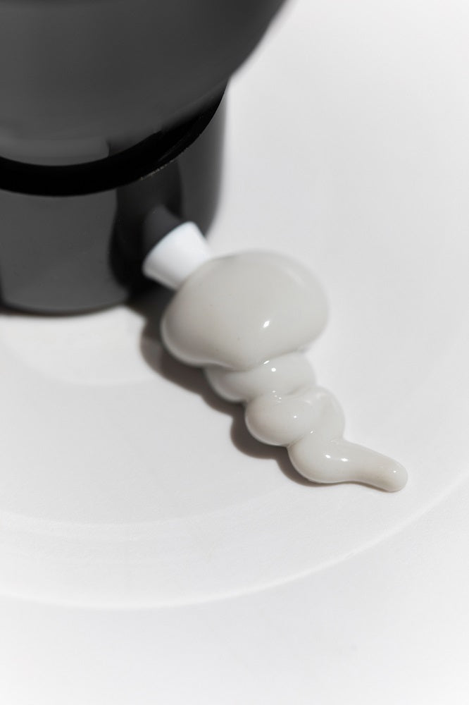 cream texture from a bottle in a white background